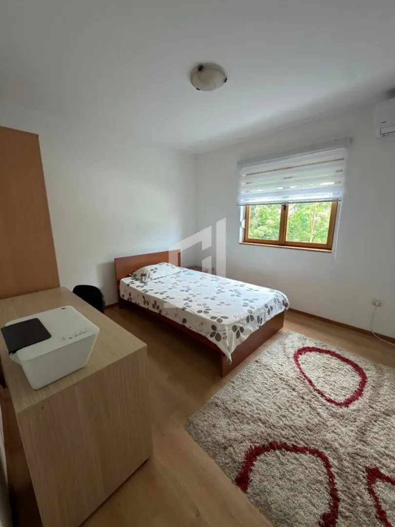 Bedroom with a bed, desk, and window.