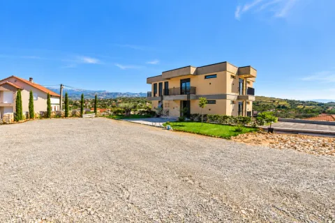 View of the exterior of the house with a courtyard and driveway. - image 6