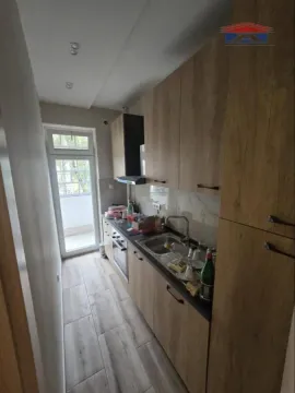 Smaller kitchen with wooden cabinets and access to the terrace. - image 7