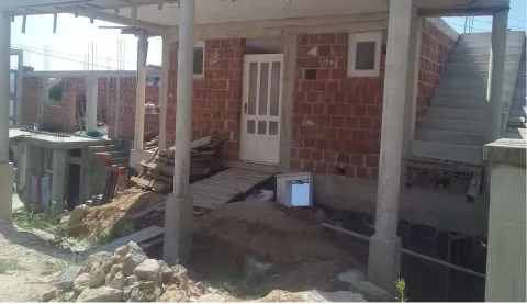 An unfinished house in the rough construction phase seen from the outside. - image 2