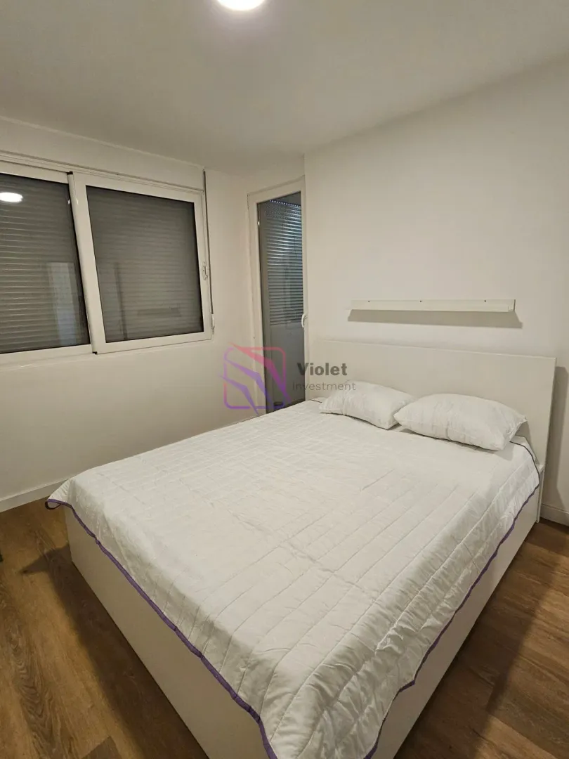 Bedroom with a double bed and a window.