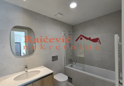 Modern bathroom with a washbasin, mirror, toilet, and bathtub with a glass partition. - image 10