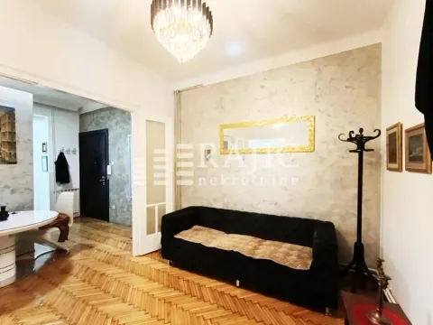 Living room with a sofa and parquet flooring. - image 3