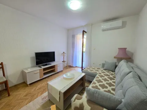 Living room with a sofa, TV, and access to the terrace. - image 2