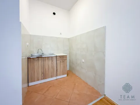 Small kitchen with a sink and cabinetry in the corner of the room. - image 5