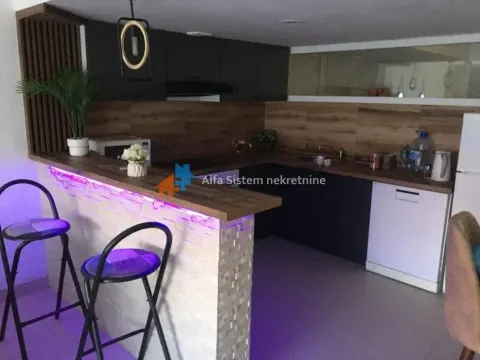 Modern kitchen with a breakfast bar and bar stools. - image 11