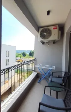 Furnished balcony with seating set and a view of the surroundings. - image 9