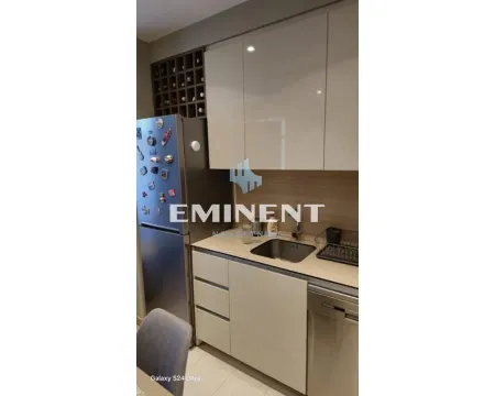 View of a section of the kitchen with cabinetry and a refrigerator. - image 7