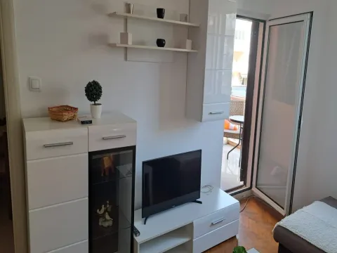 Living room with white furniture and access to the terrace. - image 4