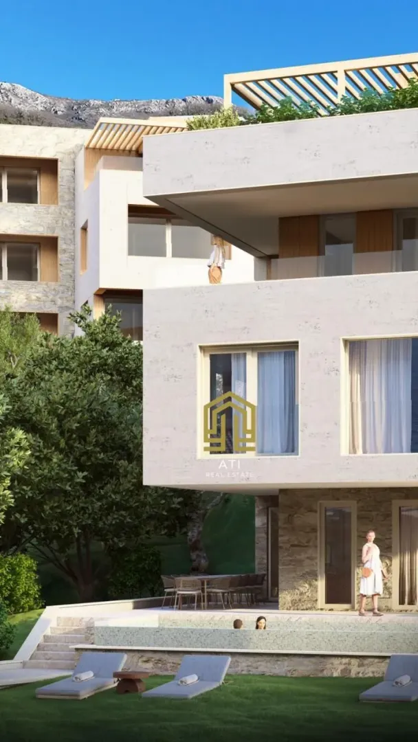 Exterior of a modern residential building with a swimming pool and yard.