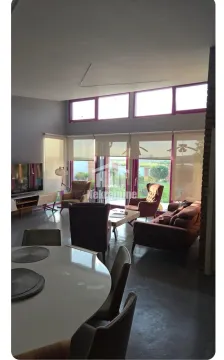 Spacious living room with seating furniture and large windows. - image 15