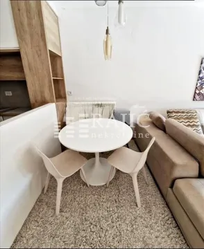 Living room with a dining table and sofa. - image 9