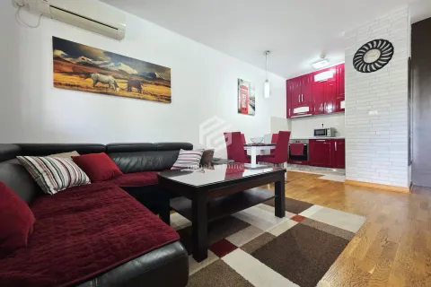 Living room with a sofa and a dining area integrated with the kitchen. - image 15