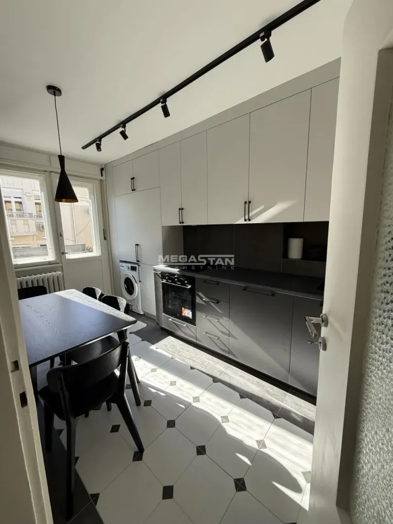 Kitchen with dining area, built-in units, and a washing machine.