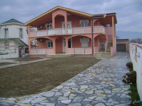 Exterior view of a two-story house with a spacious yard and a paved pathway. - image 2