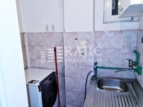Small kitchen with a sink and washing machine. - image 12