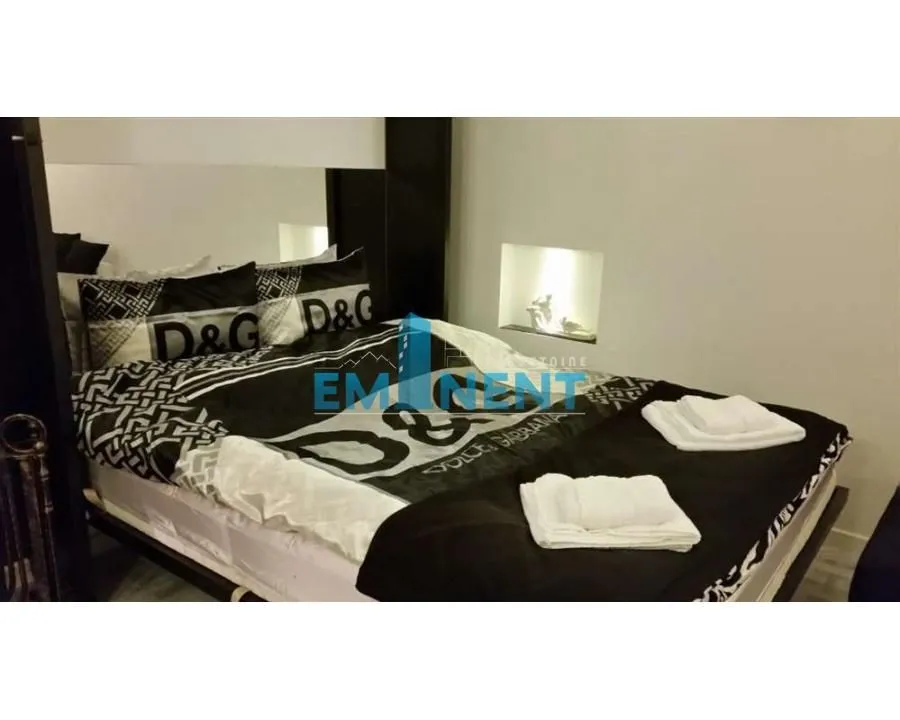 Bedroom with a large double bed and linens.