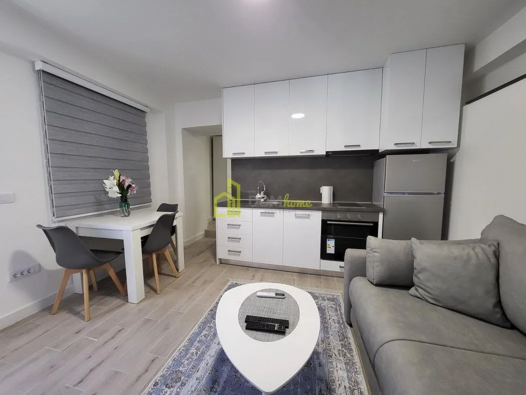 Living room with kitchen and dining area.