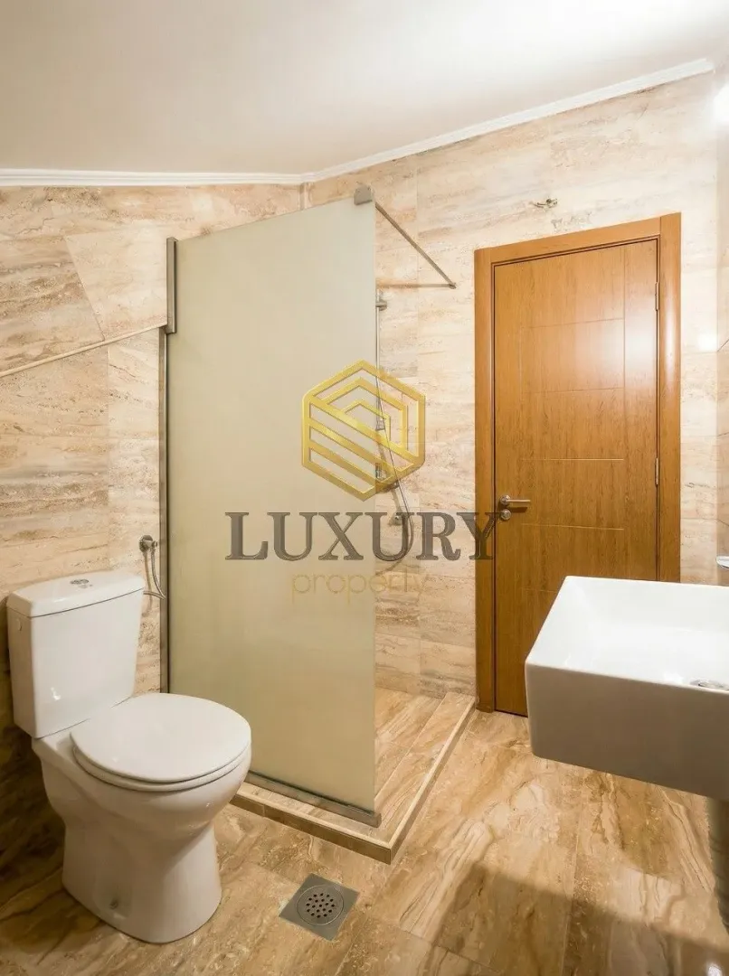 Moderne kupatilo sa tuš kabinom, WC šoljom i umivaonikom.
