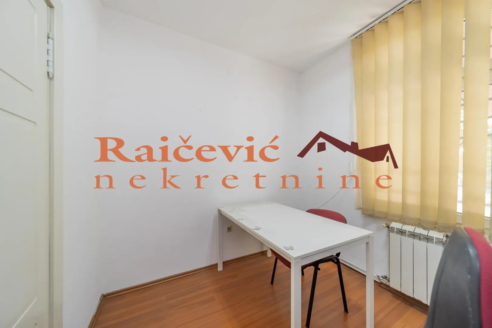 Small bright room with a desk and a chair.