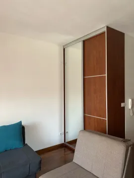 Part of a room featuring a built-in wardrobe and furniture. - image 3