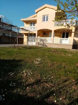 A two-story house with a spacious yard. - image 2