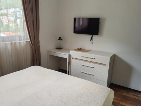 Furnished bedroom with a double bed, dresser, and television. - image 14