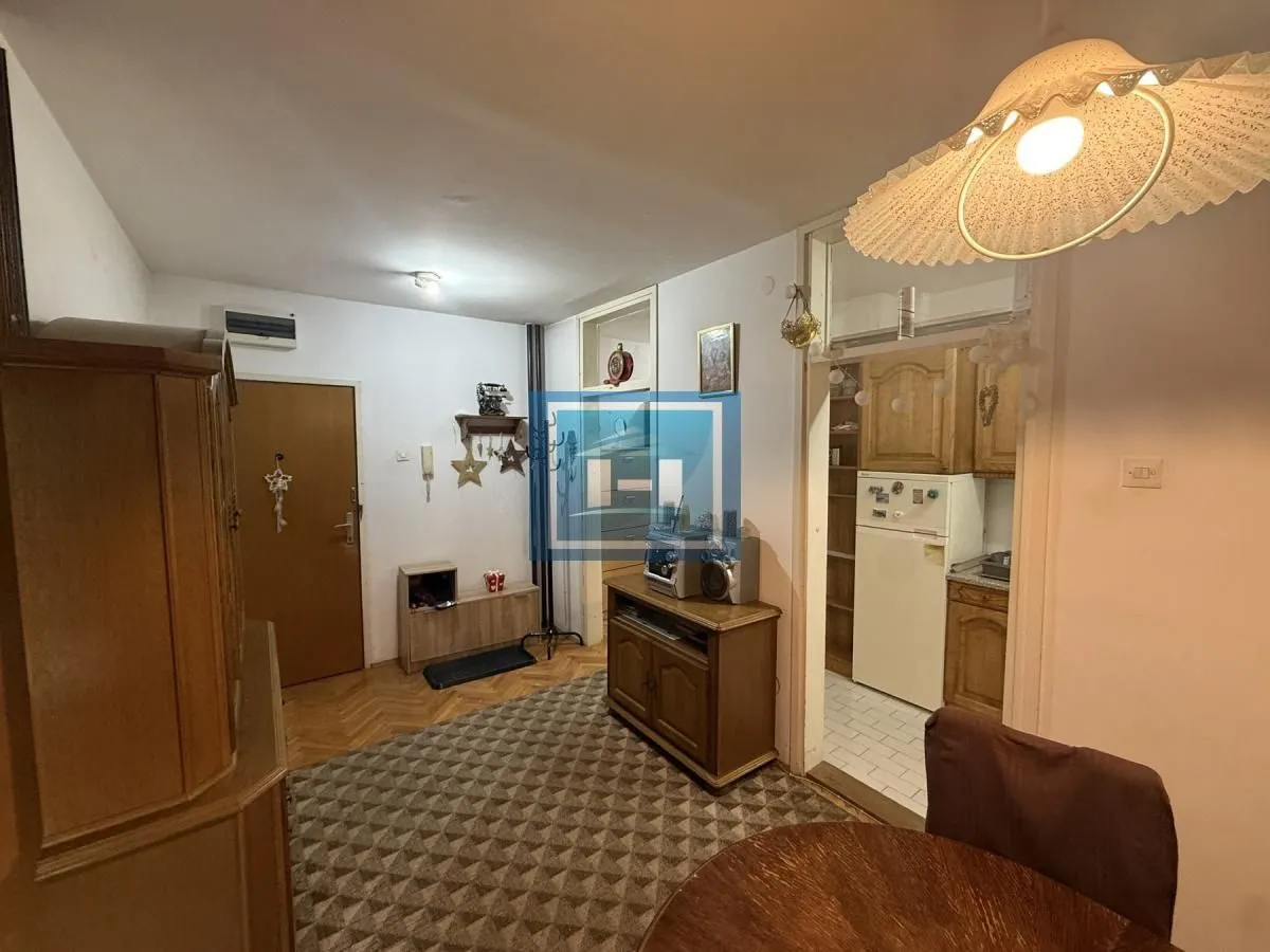 Small living room with a dining table and a view of the kitchen.