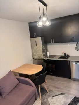 Small kitchen with a dining table and a sofa. - image 3