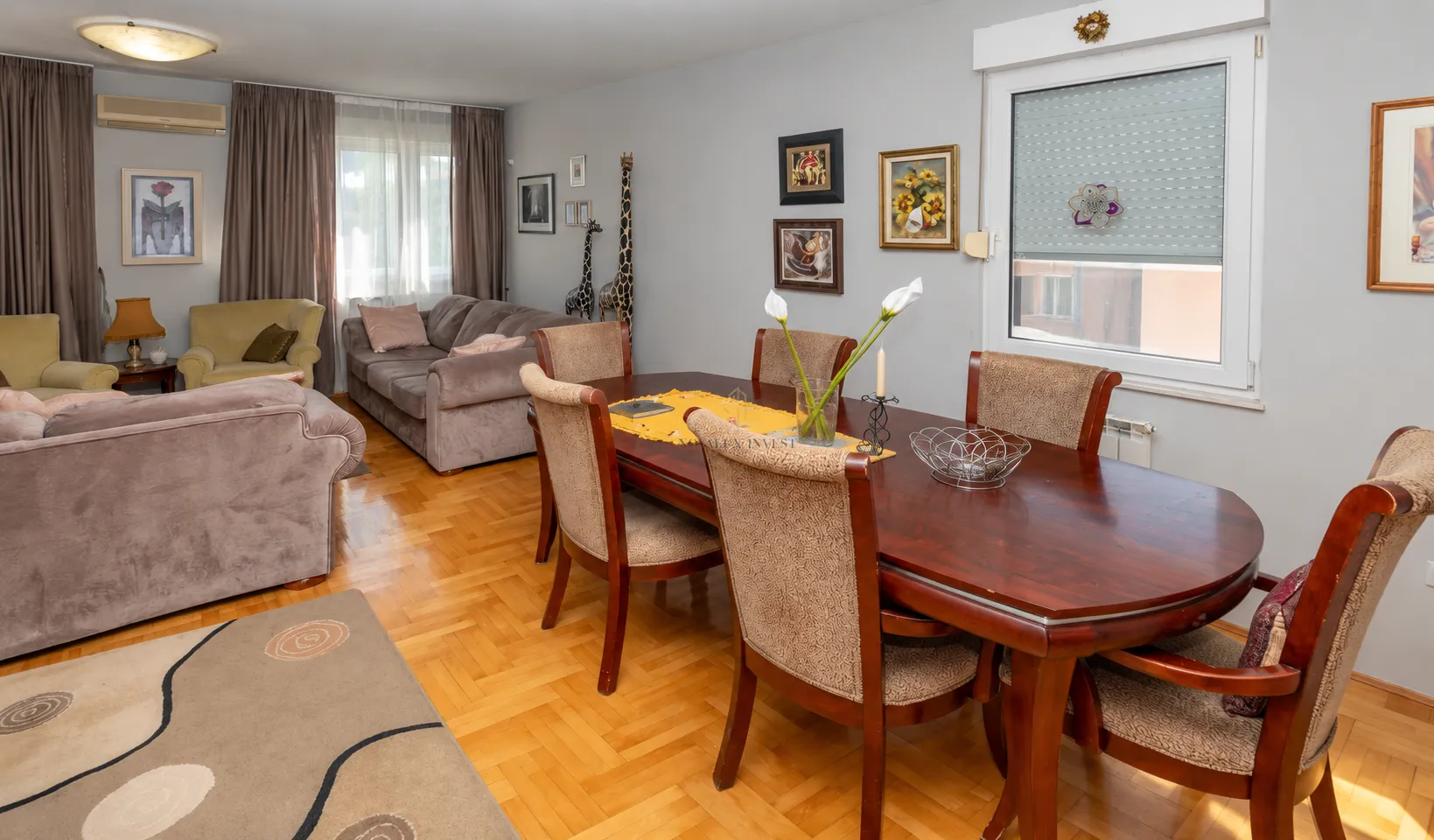 Spacious living room with a dining table and seating furniture.
