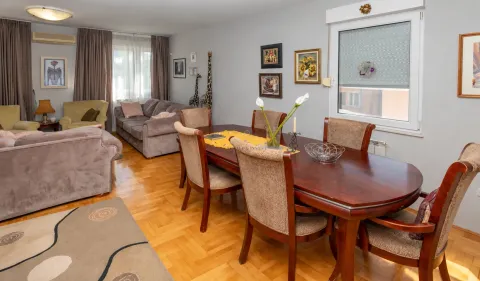 Spacious living room with a dining table and seating furniture. - image 3