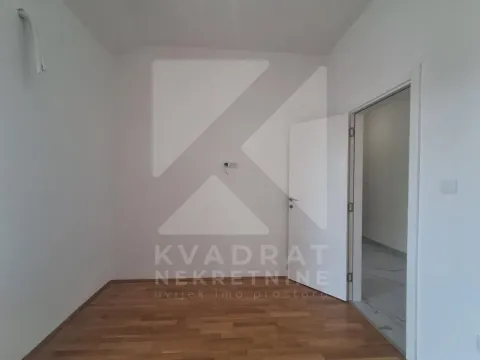 Empty room with parquet flooring and an open door. - image 11