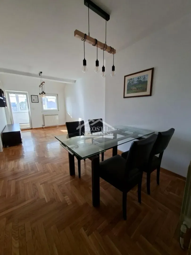Dnevni boravak sa trpezarijskim stolom i stolicama.