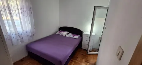 Small bedroom with a double bed, chest of drawers, and a mirror. - image 7