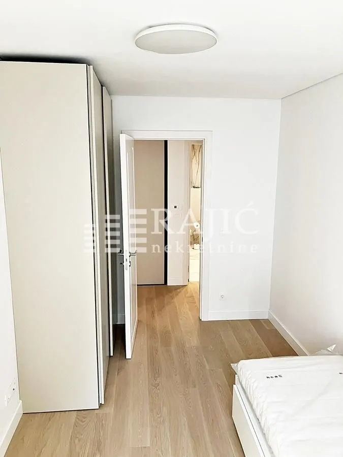 Smaller bedroom with a built-in wardrobe and a bed.