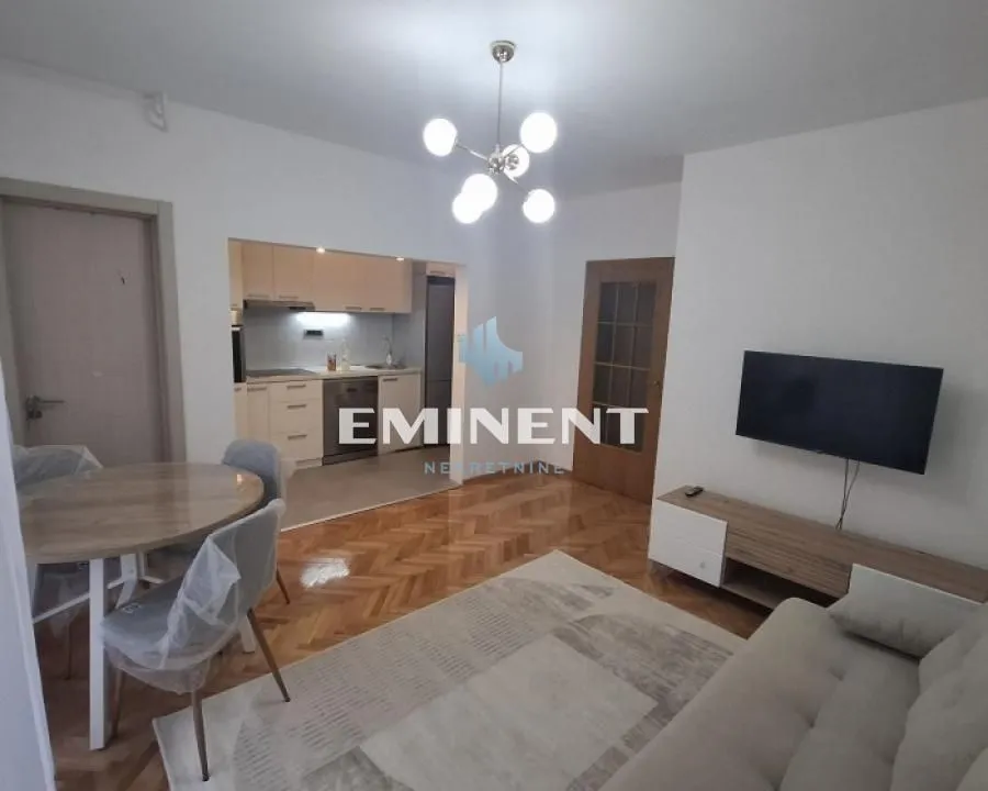 Living room with a dining area and an open passage to the kitchen.