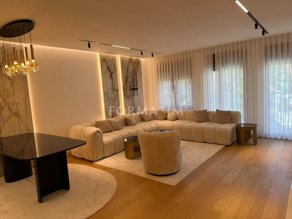 Modern living room with a sofa set, dining table, and recessed lighting.