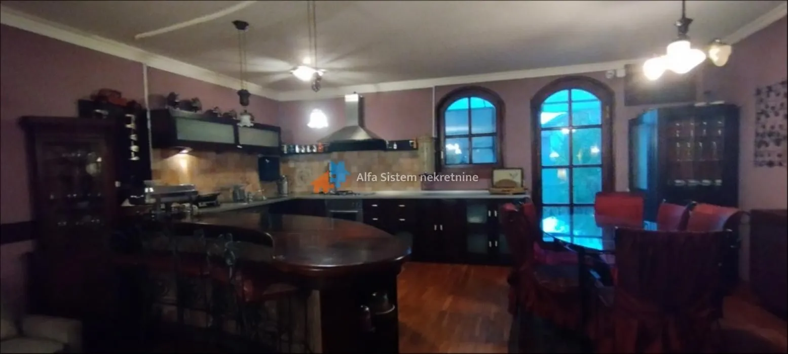 Spacious kitchen with a breakfast bar and dining area.