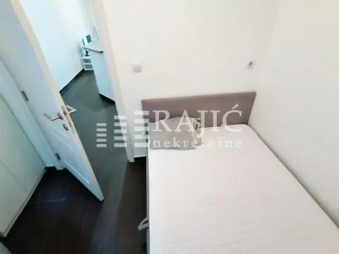 Smaller bedroom with a bed and a view of the hallway. - image 3