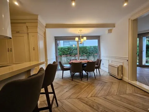 Dining area with a table and chairs connected to the kitchen. - image 11
