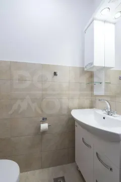 Small bathroom with a washbasin and white vanity units. - image 11