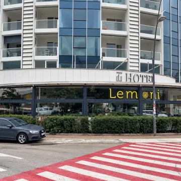 Exterior view of a modern hotel building with commercial space on the ground floor. - image 7