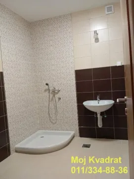 Bathroom equipped with a shower cabin and a washbasin. - image 8