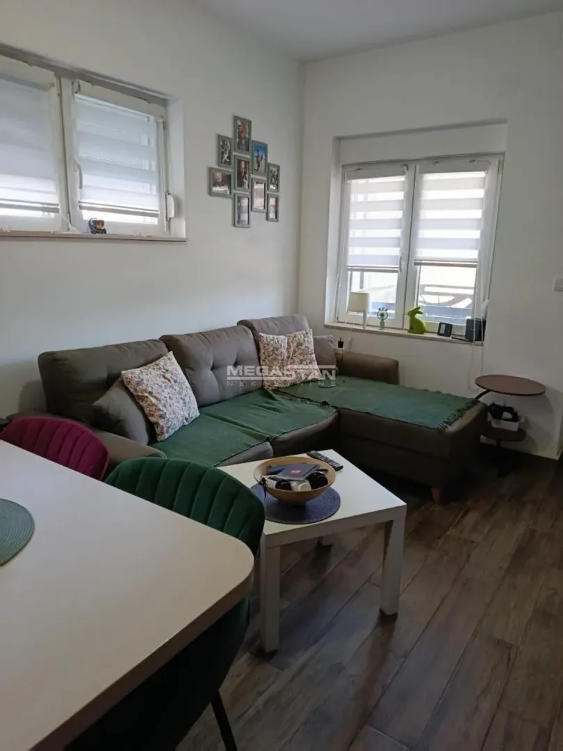 Living room with a sectional sofa, coffee table, and dining table.