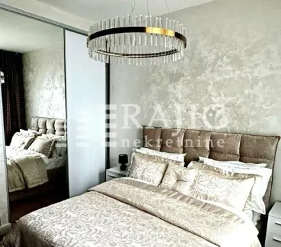 Modern bedroom with a double bed, mirrored wardrobe, and decorative chandelier. - image 7