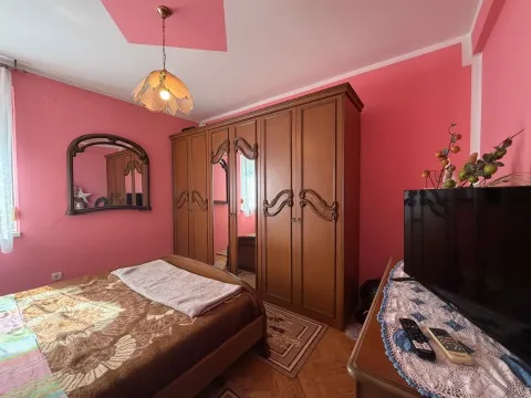 Bedroom with a double bed, wooden wardrobe and television. - image 7