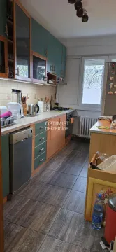 Small kitchen with wooden and green cabinets and built-in appliances. - image 15