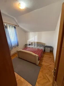 Bedroom with a double bed, bedside tables, and parquet flooring. - image 10