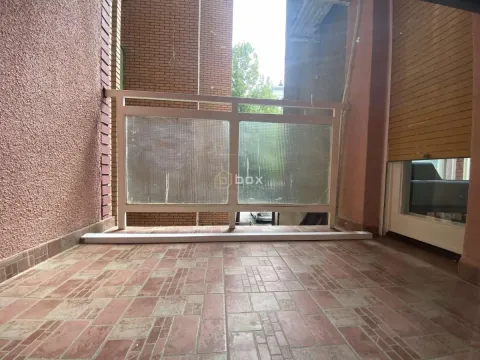Covered balcony with tiled flooring and a railing with glass panels. - image 3
