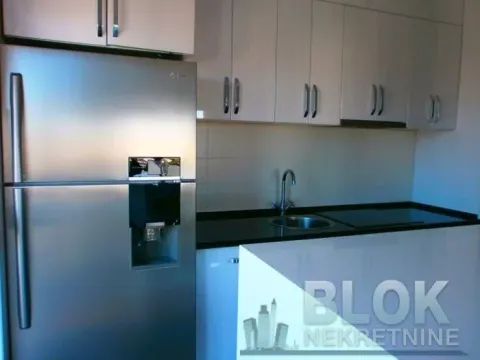 Kitchen equipped with white cabinetry and a stainless steel refrigerator. - image 9
